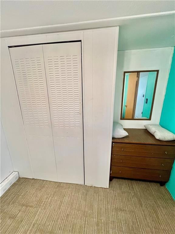 Unfurnished bedroom with carpet flooring and a closet