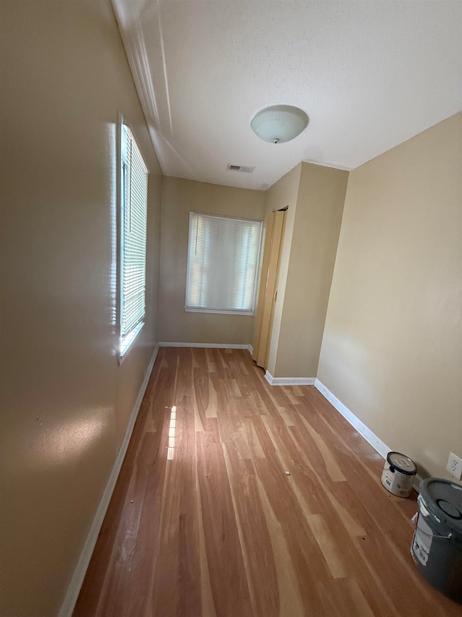 Spare room featuring wood finished floors and baseboards