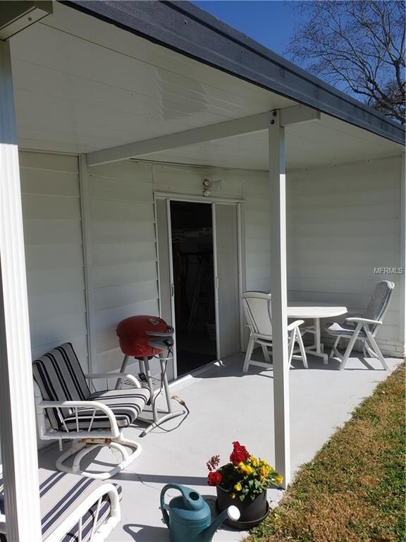 Back of house shows grilling area and open patio -
