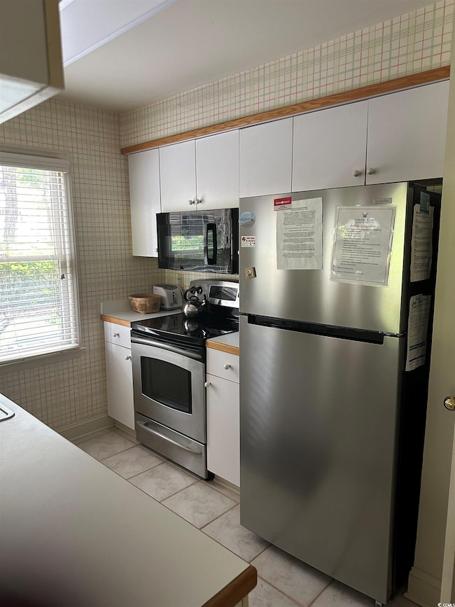 Kitchen featuring stainless steel appliances, whit