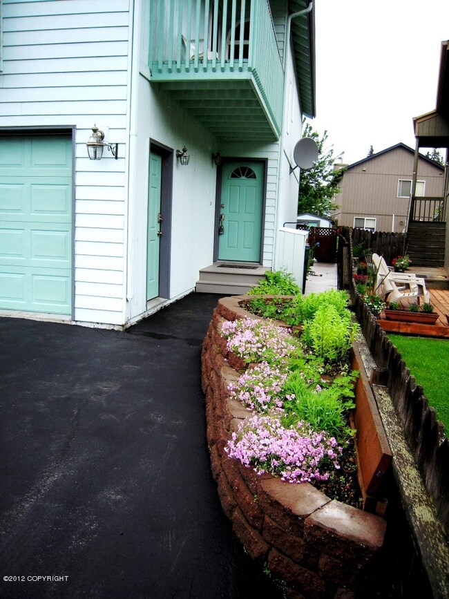 Flower planter borders fence