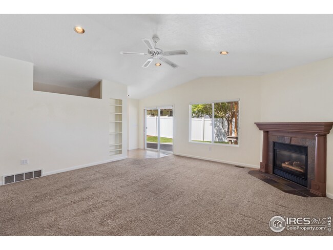 The family room features its own fireplace and built in shelves.
