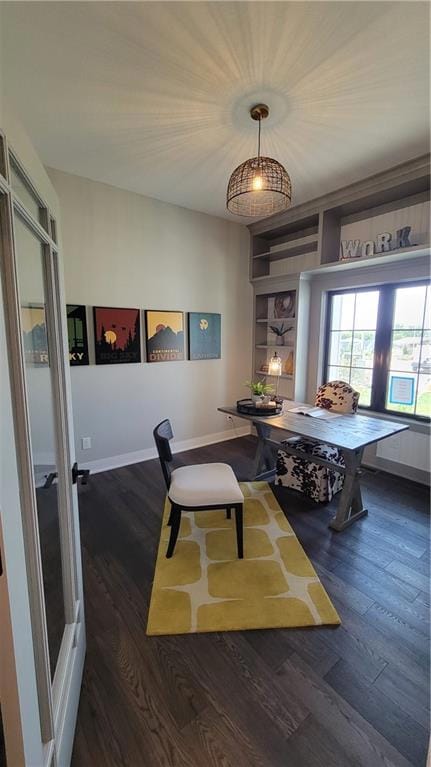Dining room with french doors, dark hardwood / wood-style flooring, and built in shelves
