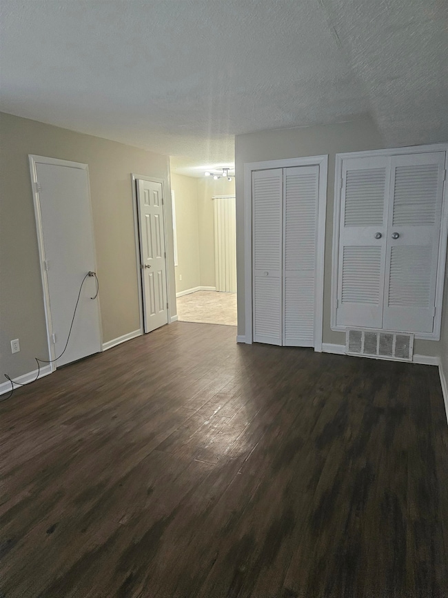 Bonus room featuring dark wood-style floors, a cha