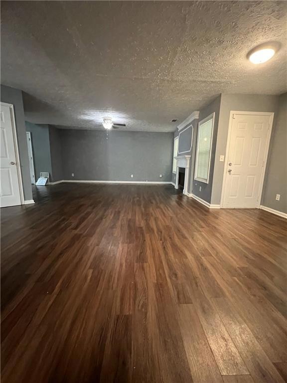 Unfurnished living room featuring dark wood finish