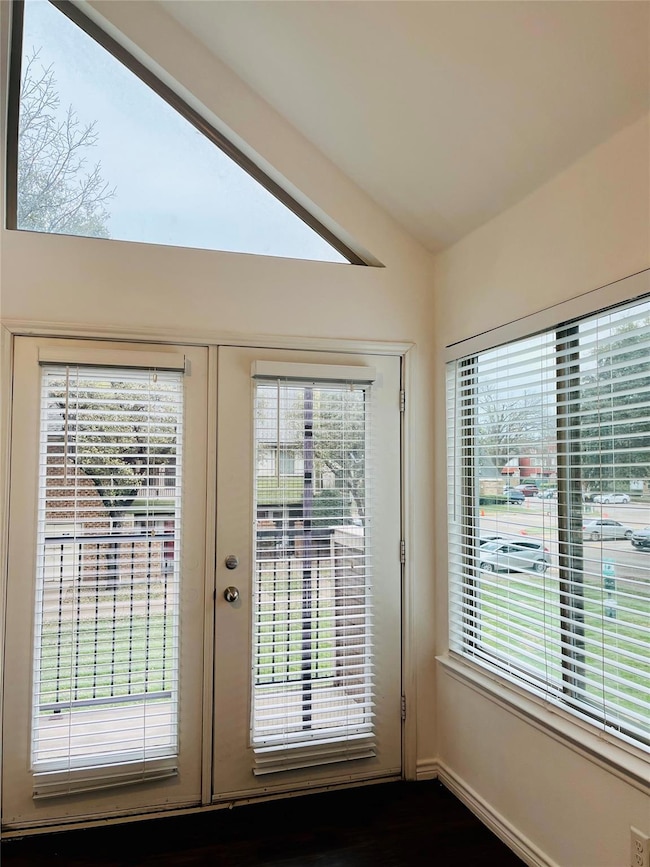 Doorway featuring vaulted ceiling and french doors