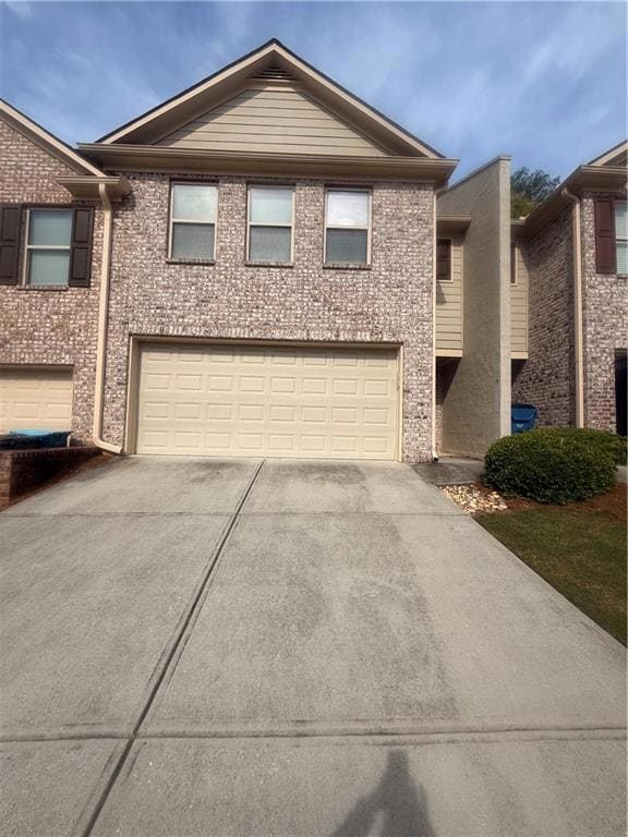 Townhome / multi-family property featuring an atta