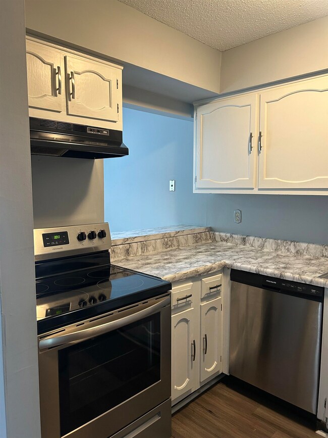 Kitchen featuring stainless steel appliances, dark