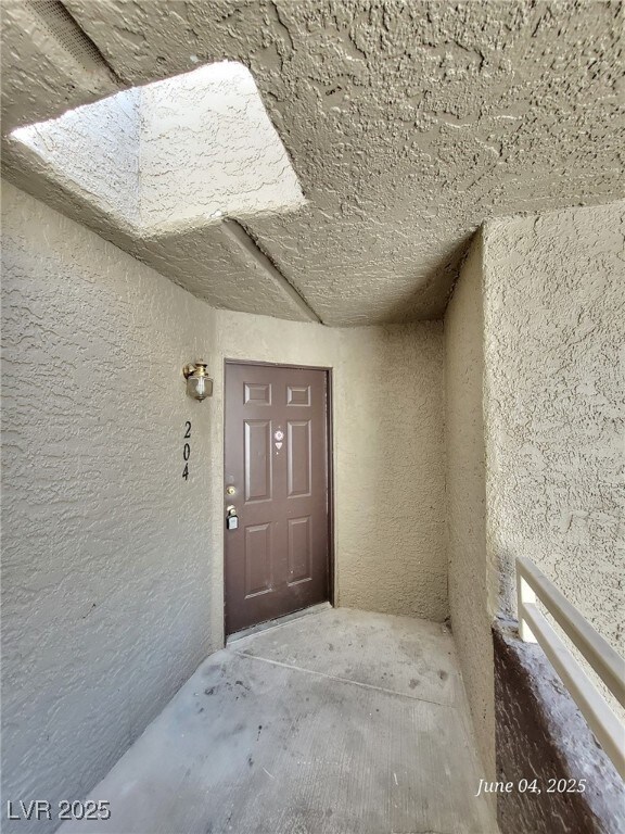 Property entrance with stucco siding