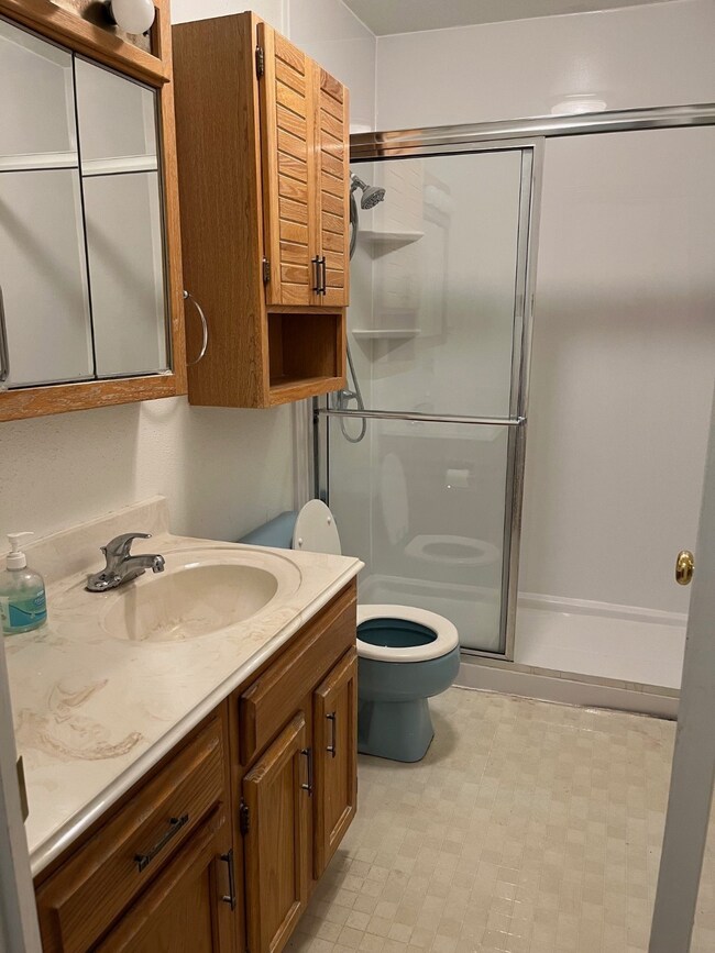 This bathroom features a compact layout with a woo