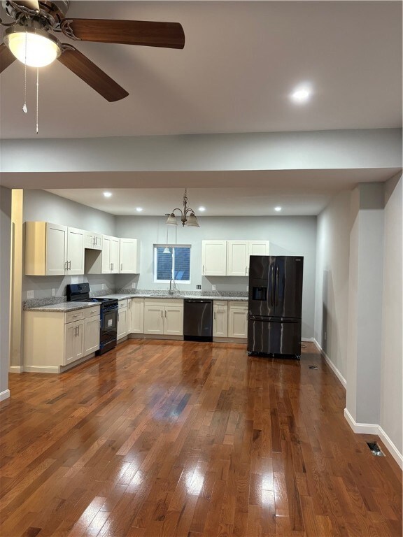 Kitchen with black stainless steel appliances.
