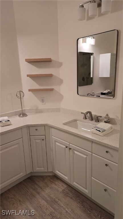 Bathroom featuring vanity and dark wood-style floors