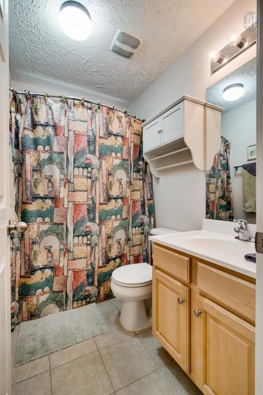 Full bath with tile floors