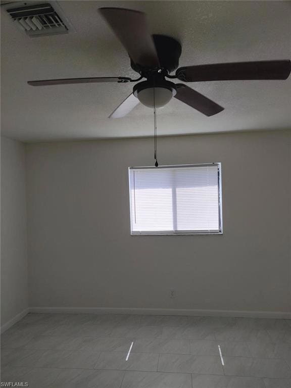 Empty room with ceiling fan and baseboards