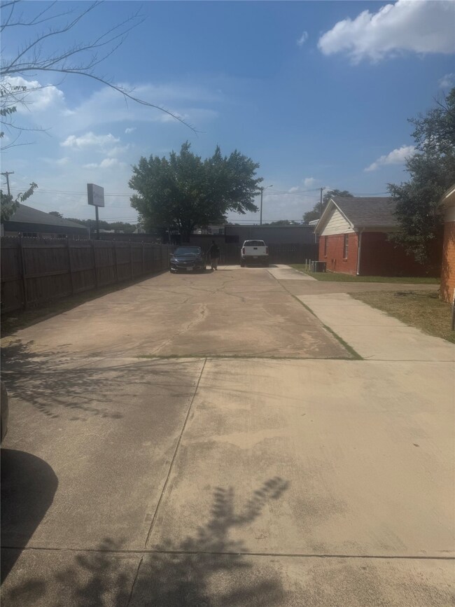 View of yard featuring concrete driveway