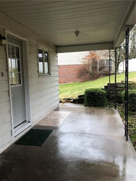 Rear concrete patio with new door.