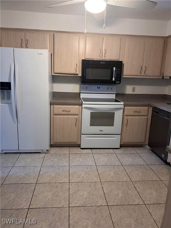 Kitchen with black appliances, ceiling fan, light