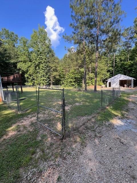 View of yard with a gate and an outbuilding
