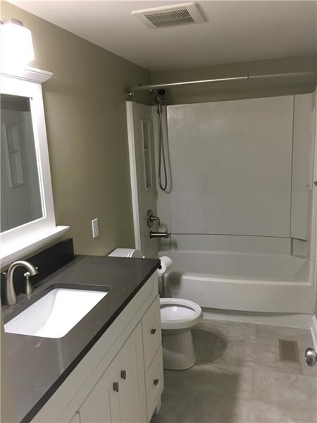Updated bathroom with granite vanity top, new floors, etc.