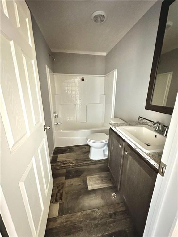 Bathroom with toilet, vanity, wood finished floors