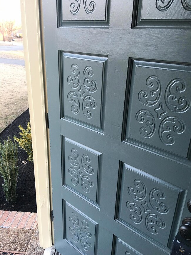 We adore this wonderful front door, with elaborate engraved panels painted an inviting blue. 