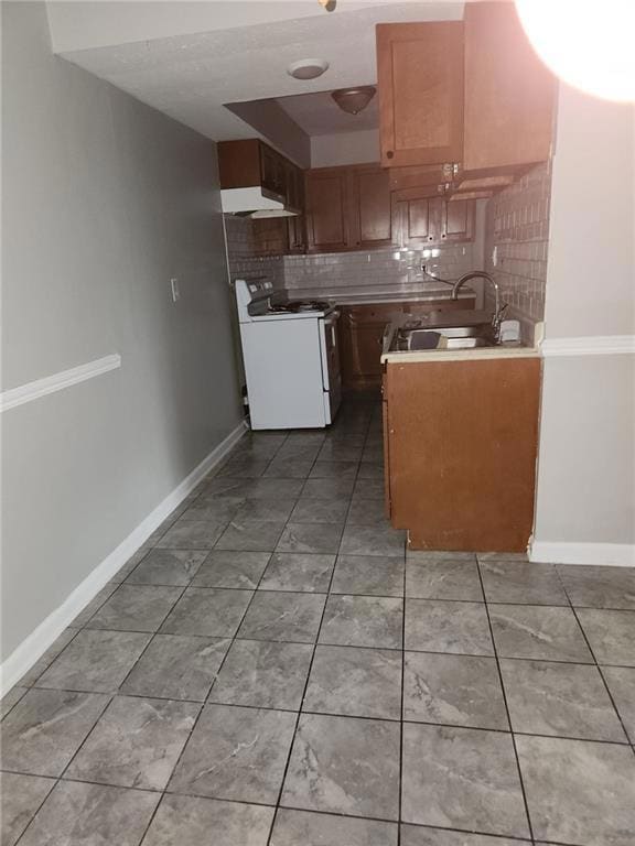 Kitchen with decorative backsplash, white stove, b