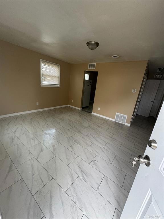 Empty room featuring light marble finish flooring