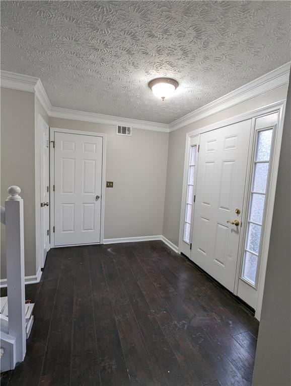 Entryway with a textured ceiling, dark hardwood / wood-style flooring, and crown molding