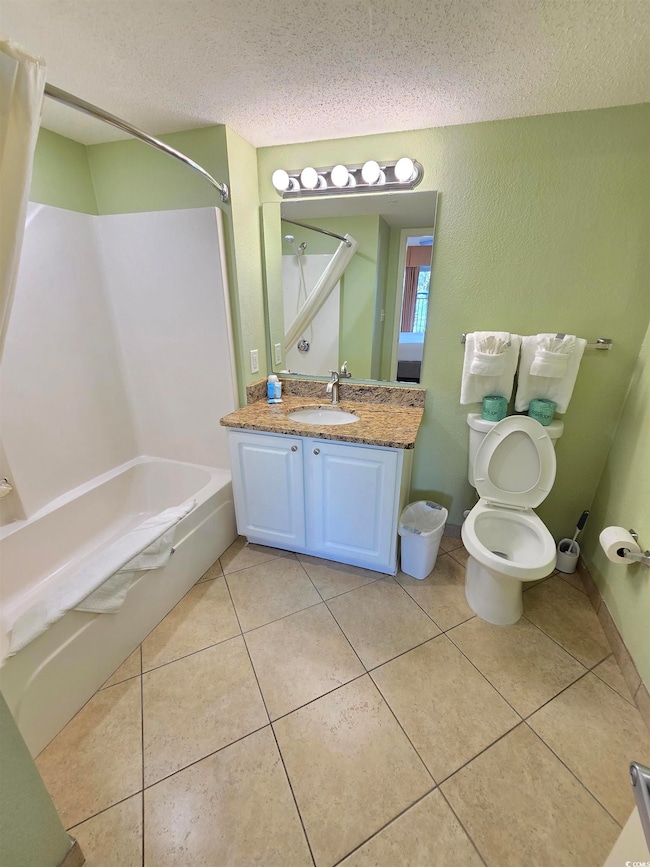 Bathroom featuring vanity, baseboards, bathtub / s