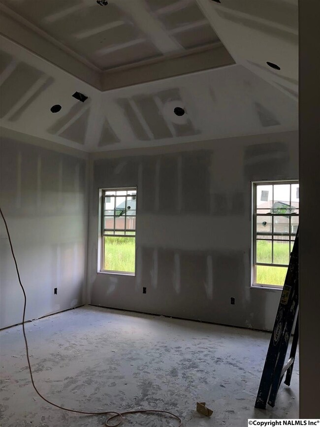 Master with beautiful high ceiling, view of private back yard. His and hers closets, tile shower.