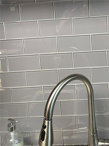 Glass subway tiles in kitchen back-splash