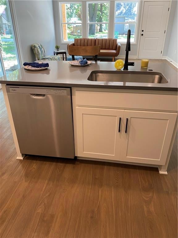 Kitchen featuring white cabinets, dishwasher, and dark wood-style flooring