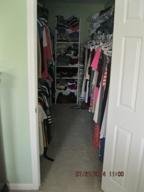 One of two large walk-in master bedroom closet.