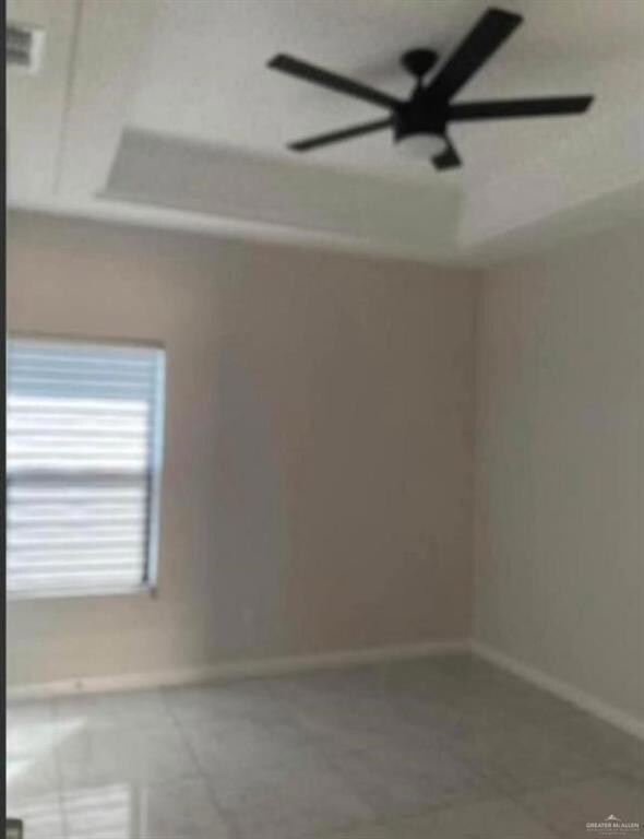 Unfurnished room featuring ceiling fan and tile flooring