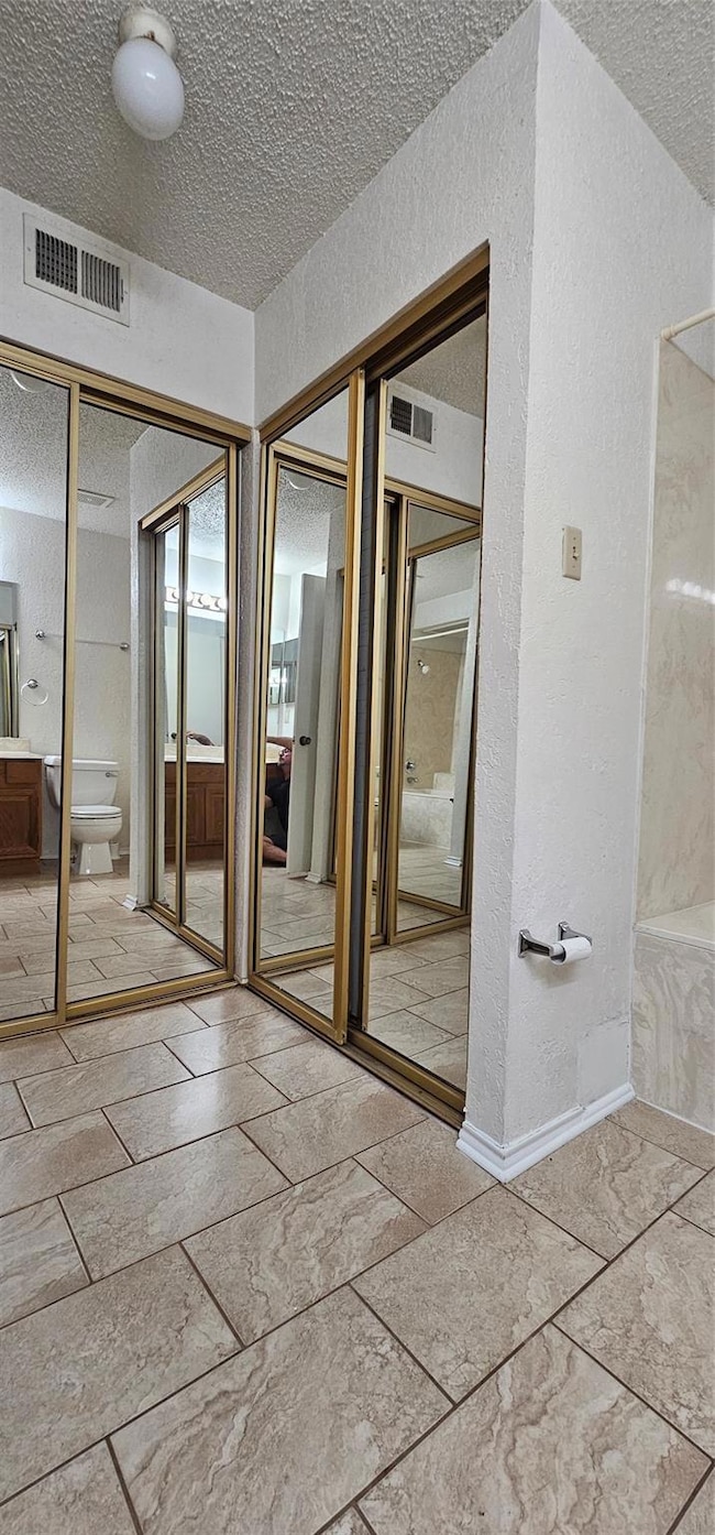 Mirrored sliding closet doors in downstairs bath