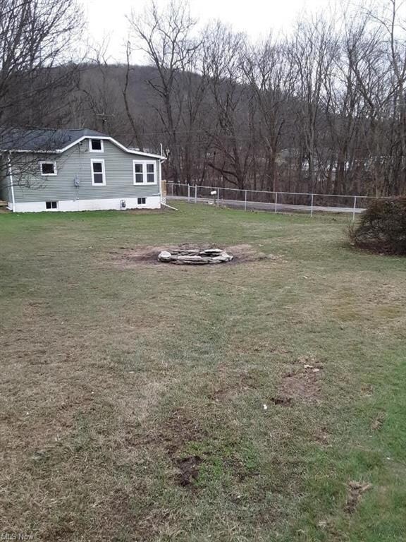 Side of home showing huge field and fire pit