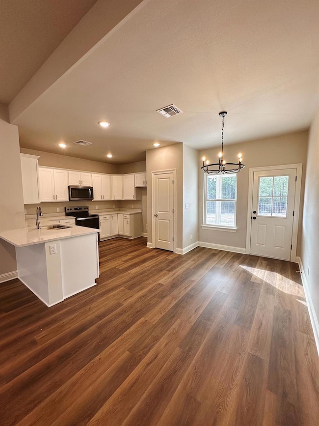 Kitchen featuring decorative light fixtures, elect
