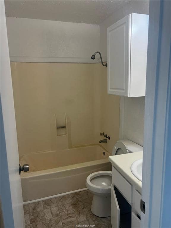 Full bathroom featuring washtub / shower combination, vanity, and toilet