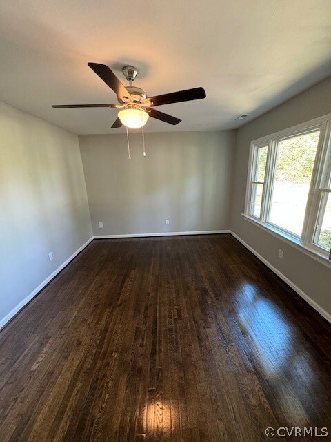 Spare room featuring dark hardwood / wood-style fl