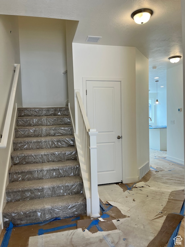 Stairway with a textured ceiling