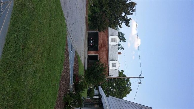 Two car garage with unfinished room above.