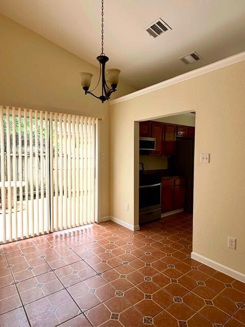 Unfurnished room featuring a chandelier, ornament