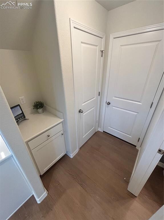 Hallway featuring dark wood-type flooring