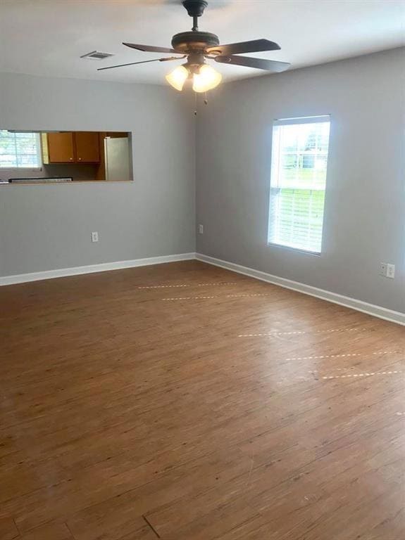 Empty room featuring ceiling fan and wood-type flo