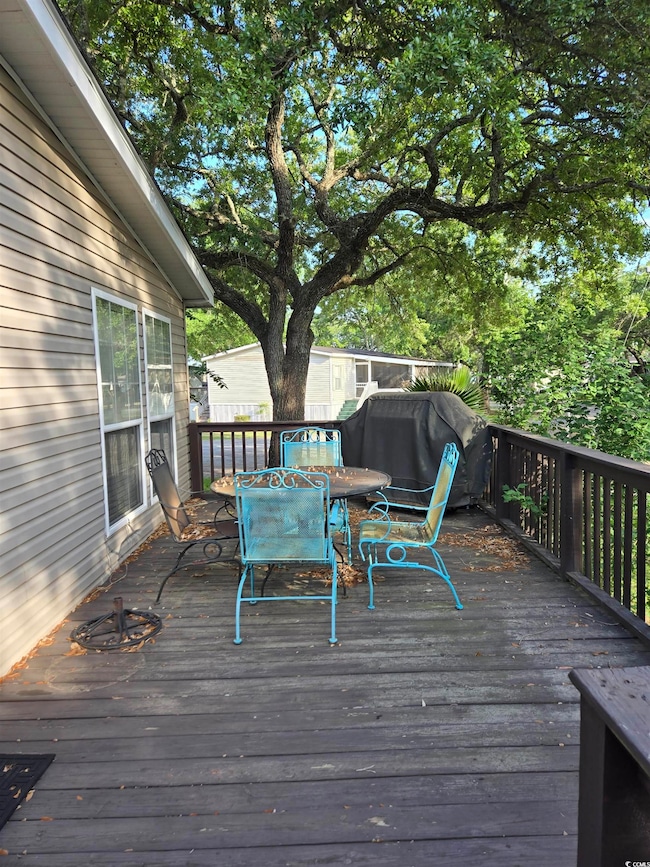 Wooden terrace featuring outdoor dining space