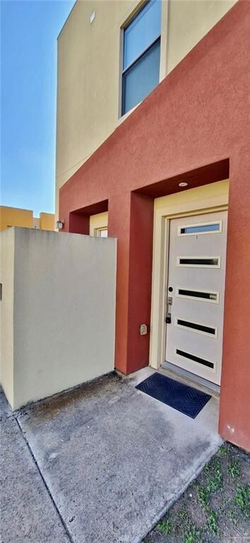 Entrance to property featuring stucco siding