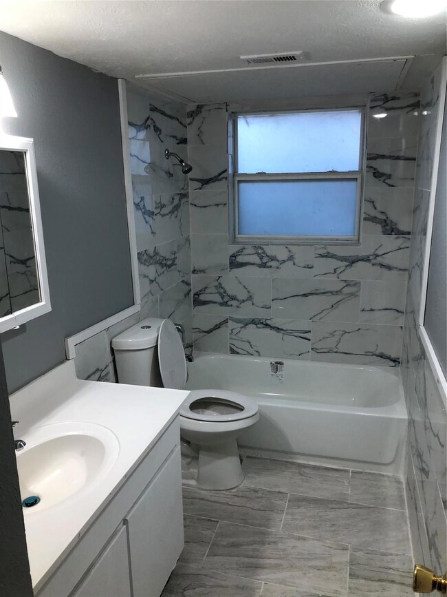 Full bathroom featuring vanity, tiled shower / bat