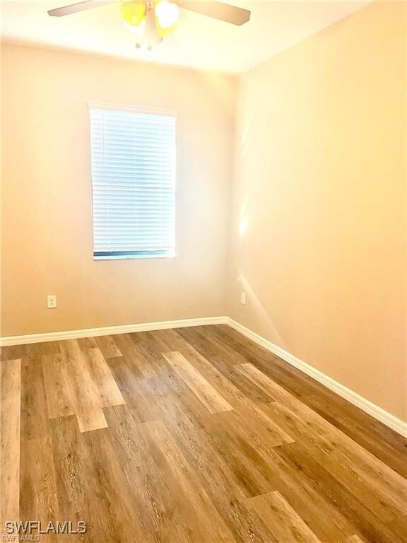 Spare room with ceiling fan, wood finished floors,