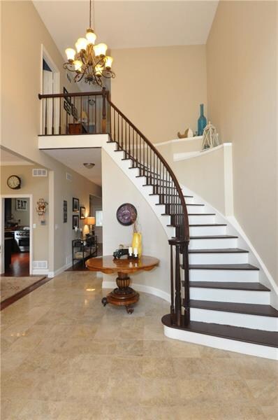 The wide staircase and ope foyer is impressive to 