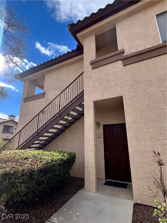 View of exterior entry featuring stucco siding